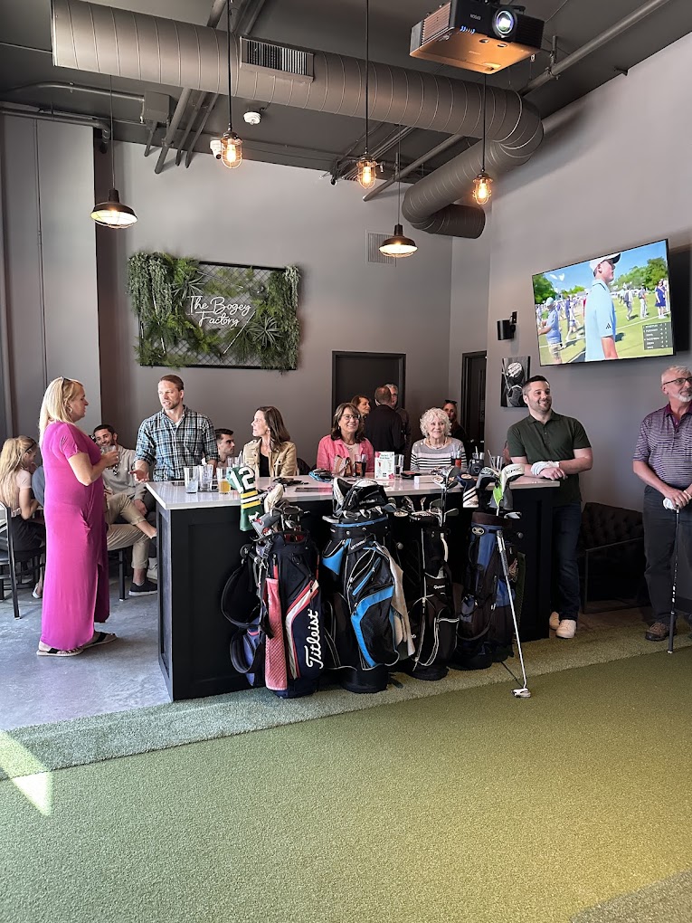 Groups socializing and watching golf on TV at The Bogey Factory