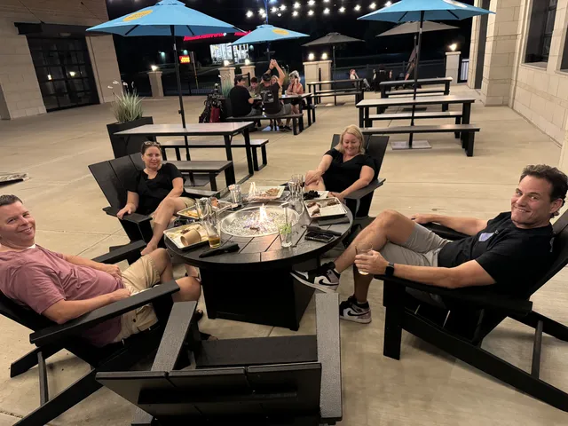 Outdoor patio dining area with umbrellas at The Bogey Factory