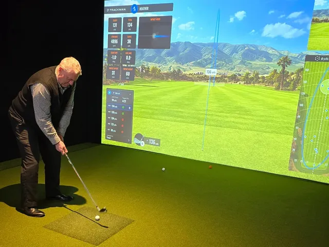 Golfer demonstrating proper swing form at The Bogey Factory simulator bay